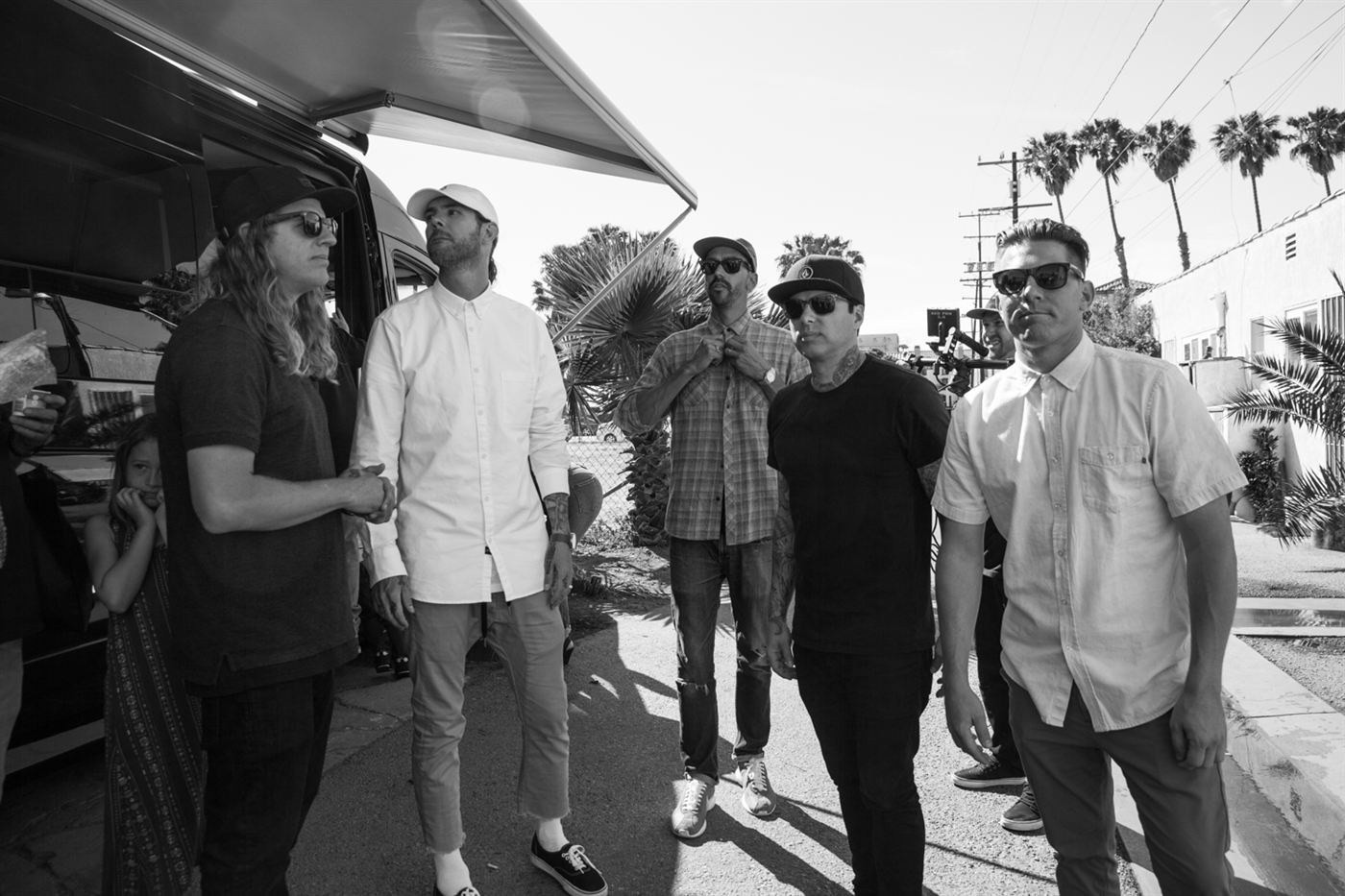 Members of Dirty Heads standing outside a tour van preparing to film the music video for That's All I Need.