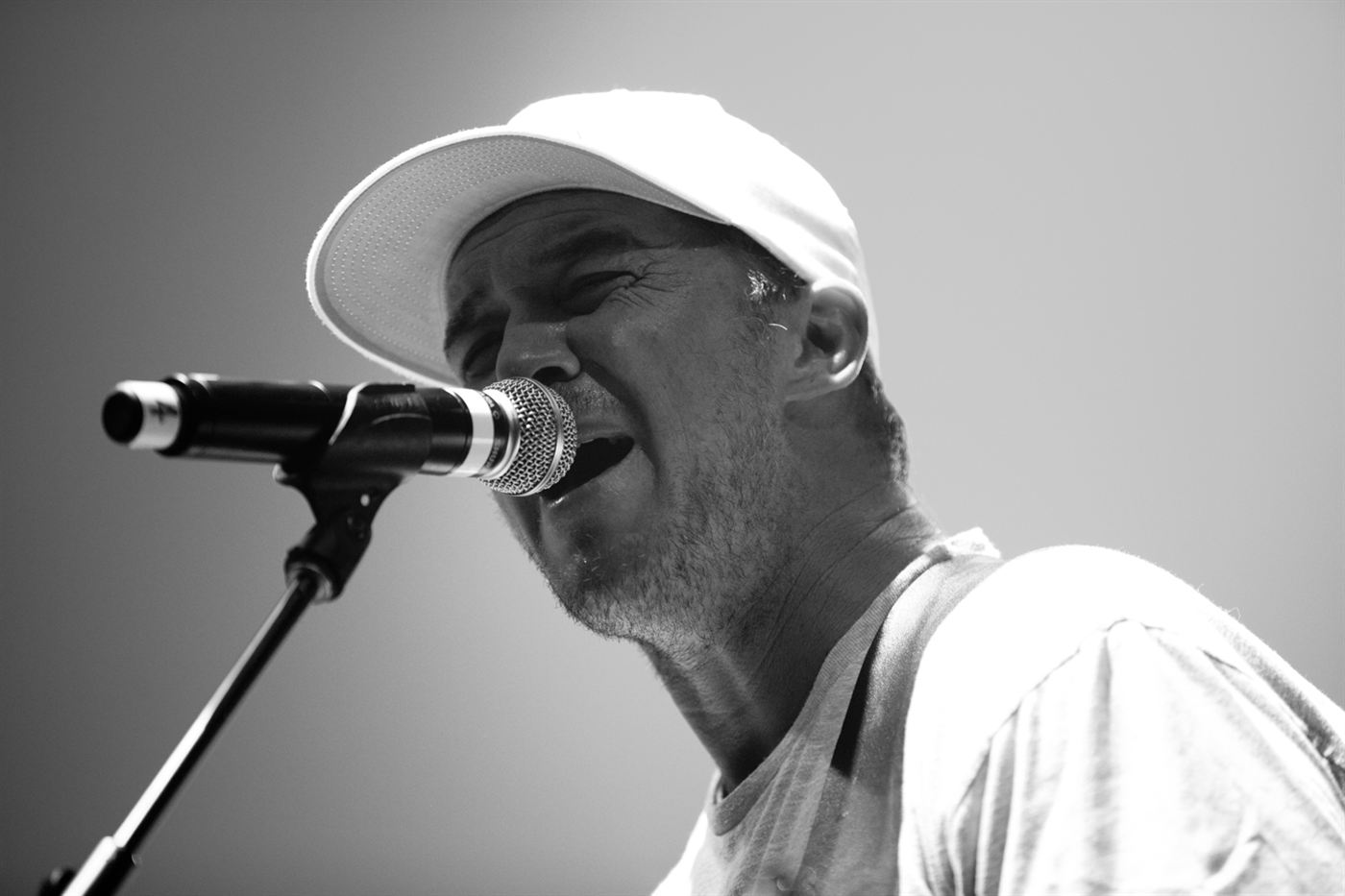 Miles Doughty of Slightly Stoopid singing into a microphone during a live performance in Santa Rosa.