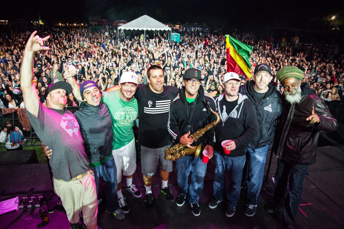 Live festival performance photographed from the crowd with the stage and audience visible.
